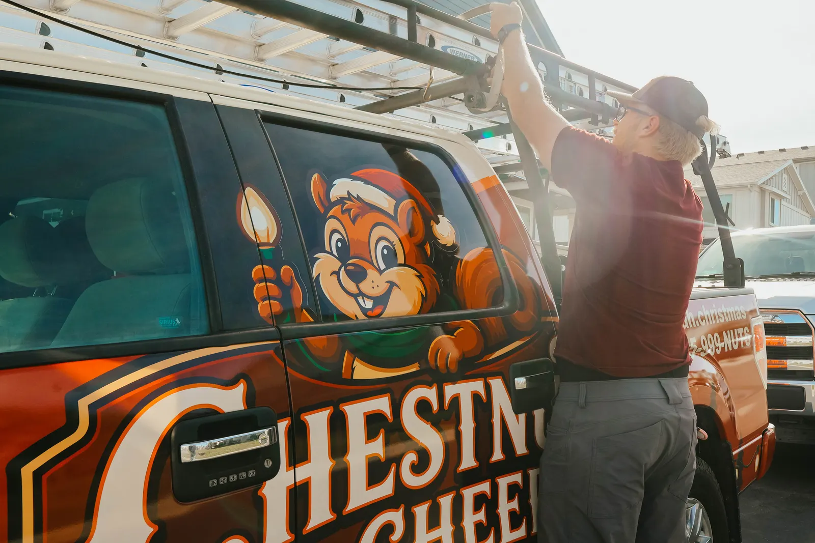 Technician unloading a ladder from the Chestnut & Cheer service truck