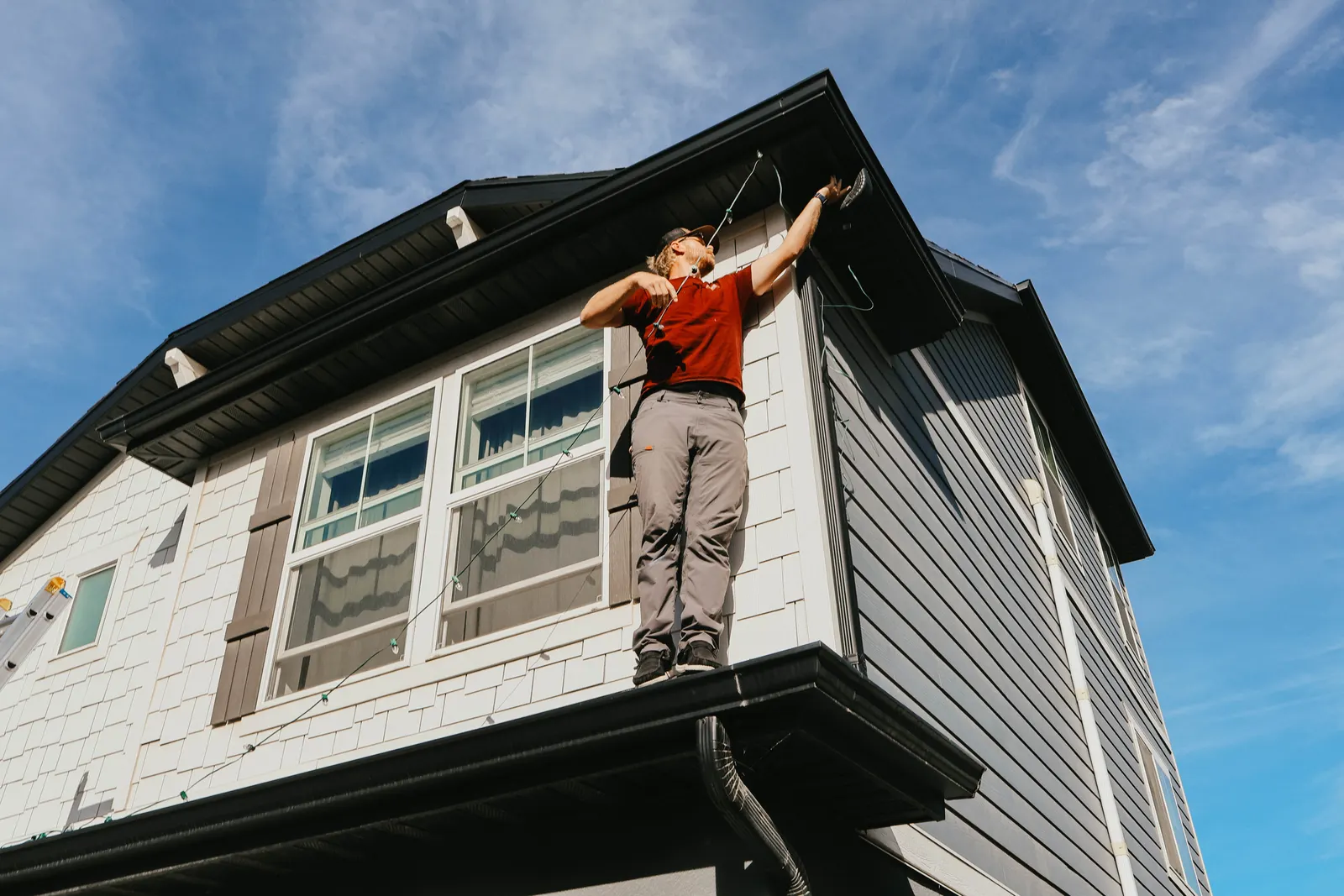 Professional Christmas light installation on a two-story Utah roofline