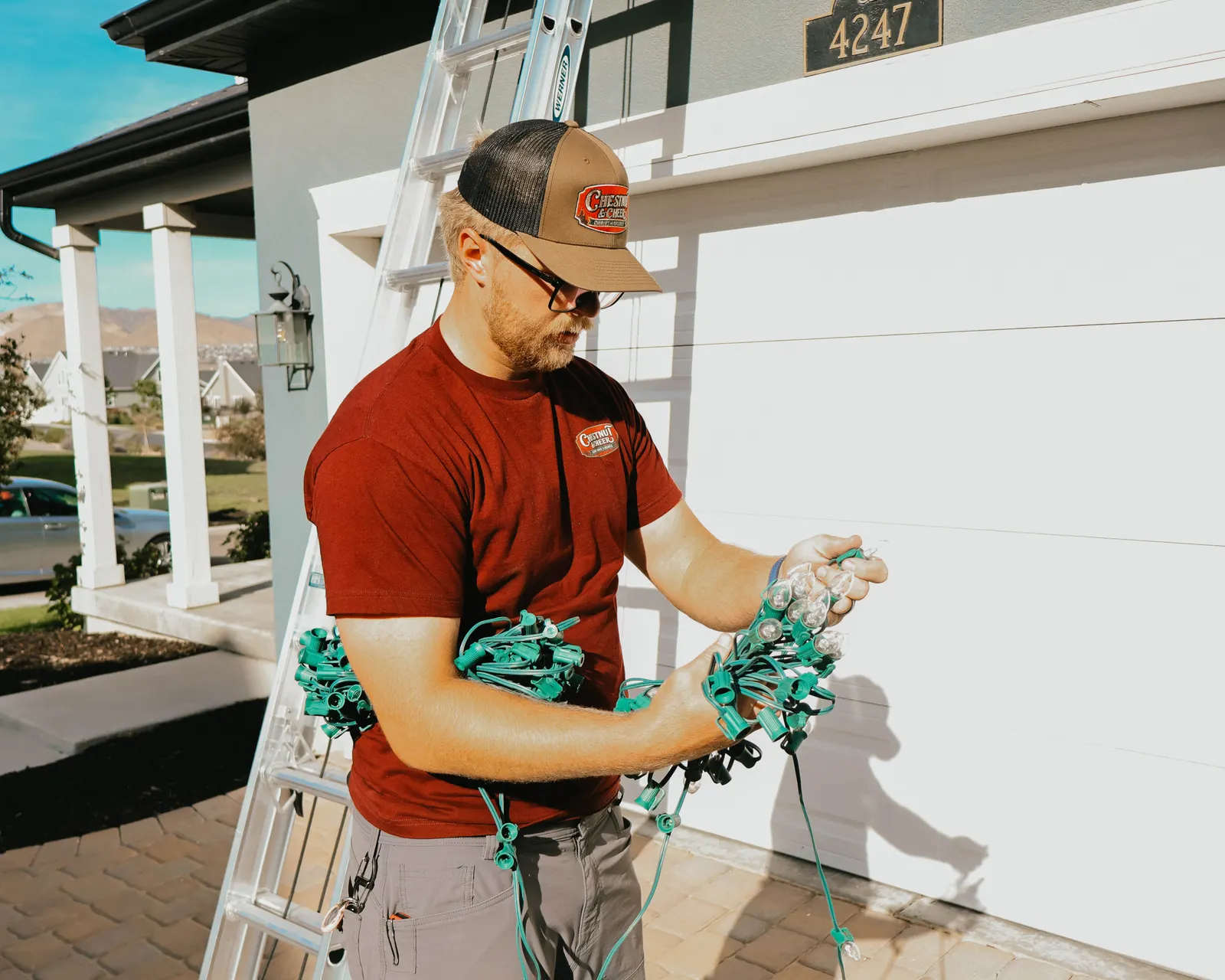 Technician bundling commercial-grade Christmas lights before installation