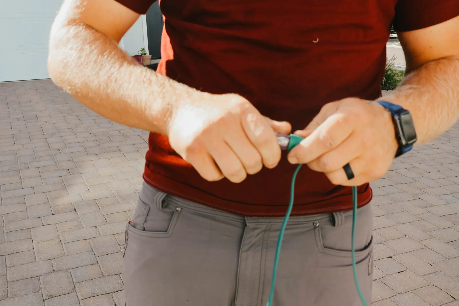 Technician checking a Christmas light bulb before installation