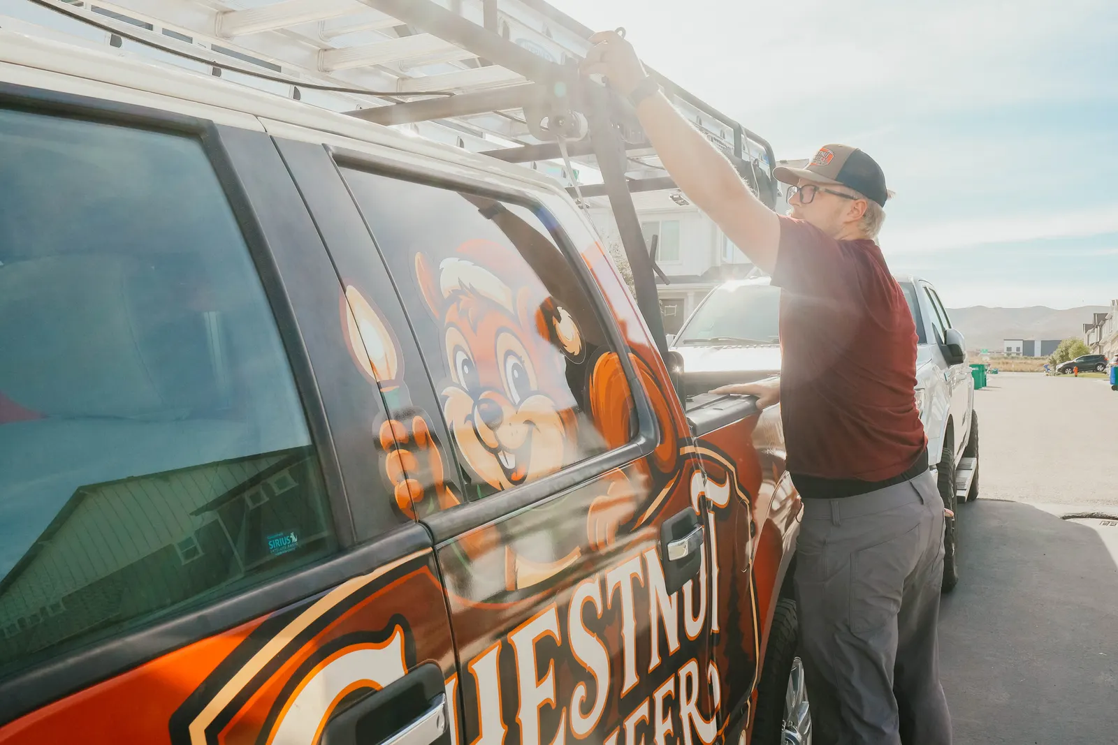 Technician preparing a ladder for professional Christmas light installation